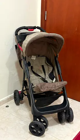 Used beige baby stroller in good working condition