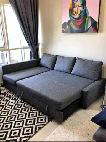 L-shaped grey fabric sofa bed — convertible sectional in good condition