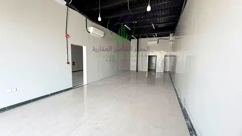 Annual warehouse for rent in Industrial Area 12 with an area of 3,100 sq ft, one month free, 2 bathrooms, kitchen, mezzanine, and located on a main ro