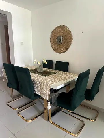 Modern white dining table with 6 emerald velvet cantilever chairs