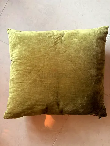 Olive green velvet throw cushion for couch, reverse side light grey, measuring 45x45 cms, AED 25