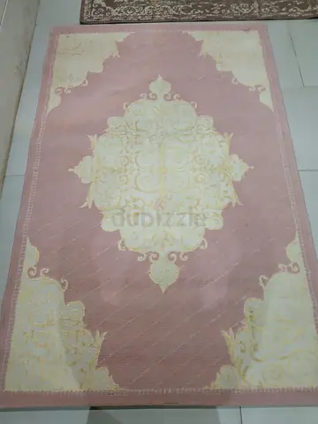 Light pink and cream decorative area rug -