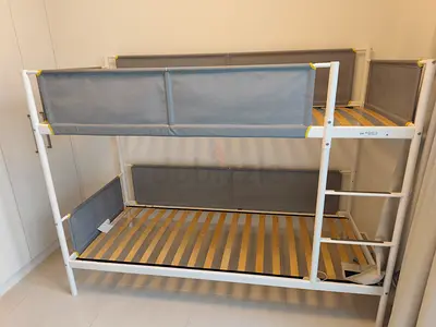 IKEA White metal bunk bed frame with grey fabric guard rails — good condition