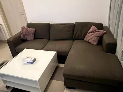 L-shaped brown fabric sofa with coffee table