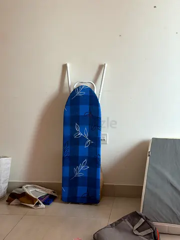 Standard ironing board with blue cover in good condition