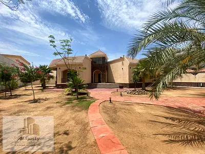 Elegant Villa for Sale in Al Rahmaniya Sharjah with Spacious Land Green Yard Master Bedrooms Living Room Majlis and Prime Location