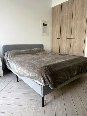 Grey fabric single bed frame with mattress base - good condition