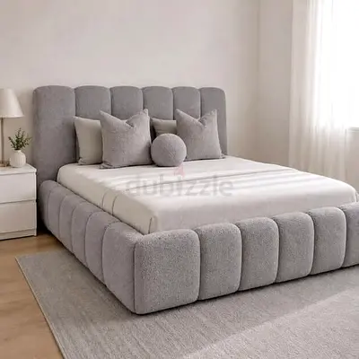 Modern upholstered king bed with padded headboard and base