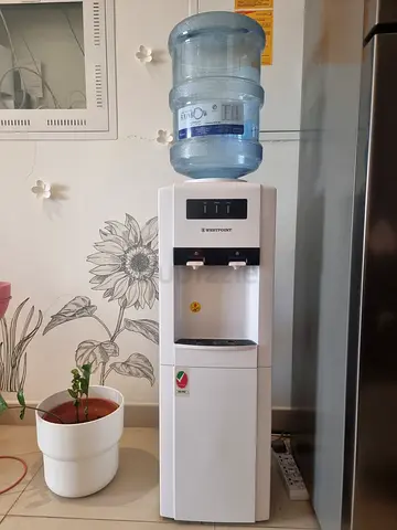 Standing Water Dispenser. Hot and cold water with an mini fridge. Excellent Working Condition