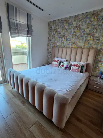 Beige upholstered platform bed with padded headboard and footboard - Excellent like new condition