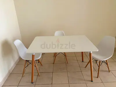 Modern white dining table with 3 matching chairs - compact set