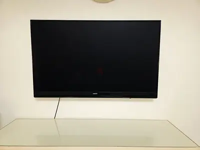Samsung 49-inch LED TV mounted on wall - good condition