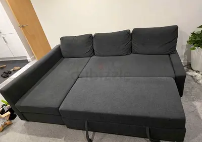 Dark grey L-shaped sofa bed with storage - good condition