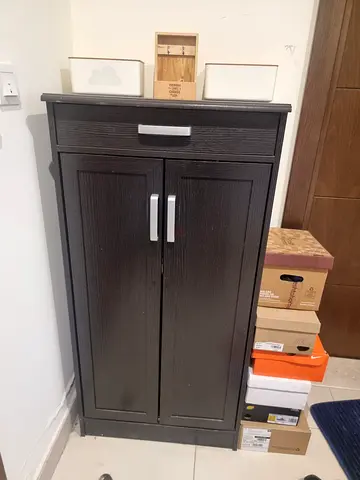 Dark brown wooden storage cabinet with double doors - good condition