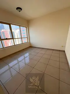 A spacious 2-bedroom apartment with a living room available for annual rent in Al Khan, located dire