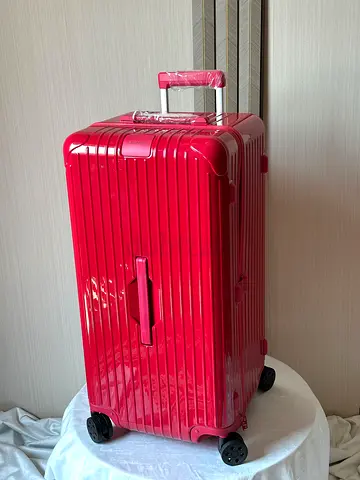 Red Rimowa Essential Trunk plus large lightweight suitcase