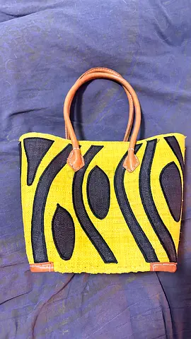 Yellow and black woven tote bag with leather handles