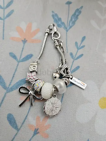 Silver charm bracelet with mixed beads and pendant