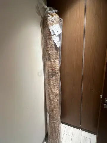 Large beige woven area rug - new, still in plastic