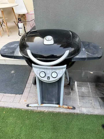Used outdoor gas barbecue grill with side shelves .. with gas Cylinder included in the price
