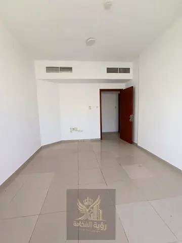 One month free; excellent view overlooking Al-Wahda Street; includes a balcony, two bedrooms, a living room, and two bathrooms.