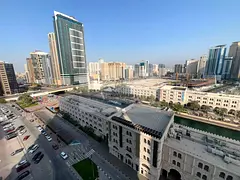 2-Bedroom Apartment for Annual Rent in Al Qasba with Balcony, Open View, Built-in Wardrobes, Free AC