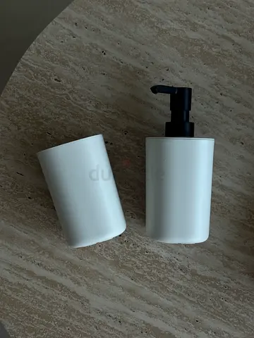 White IKEA bathroom soap dispenser and toothbrush holder