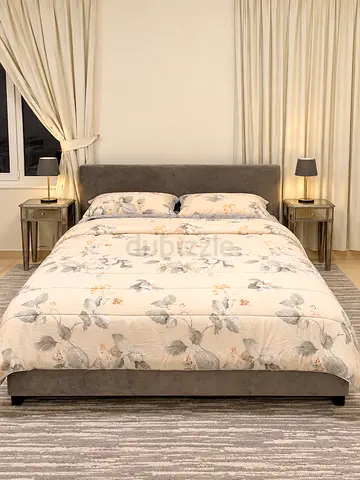 Queen bed with upholstered headboard and side tables - good condition