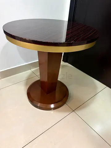 Round wooden side table with brass trim - good condition