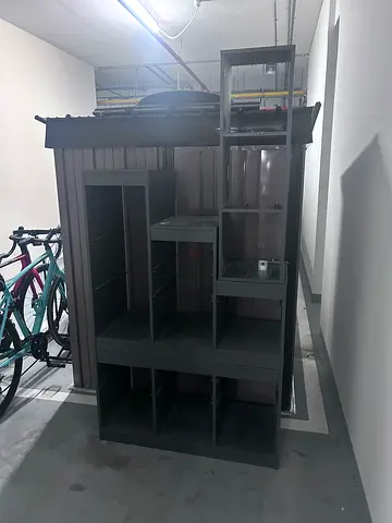 Large dark grey entertainment center / TV unit with shelves
