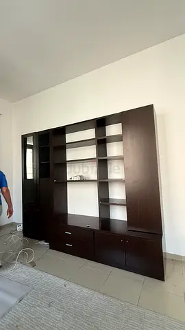Large dark wood entertainment/TV unit with shelves and cabinets