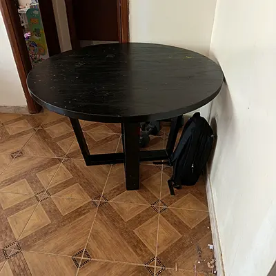 Solid black round wooden dining table - good condition