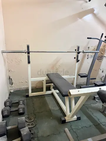 Used home bench press rack with barbell and dumbbells