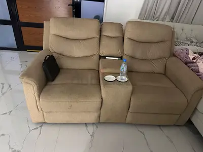 Beige 2-seater reclining sofa with center console