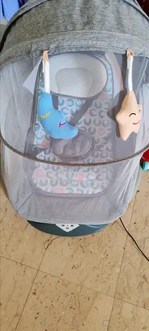 Grey baby bassinet / cradle with canopy and toys