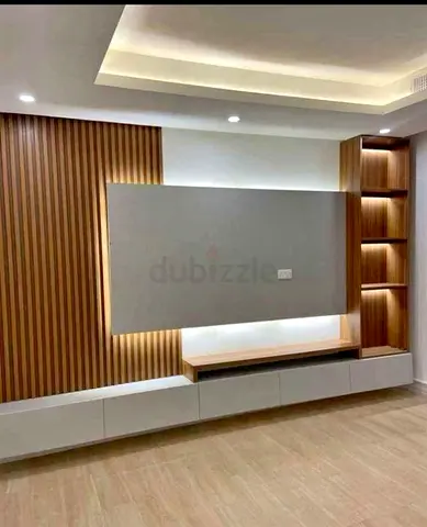 Customised Modern built-in TV entertainment unit with shelving and LED lighting