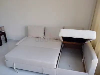 Light beige fabric L-shaped sofa with storage and pull-out bed