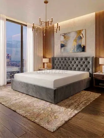 Grey upholstered king-size bed with tufted headboard