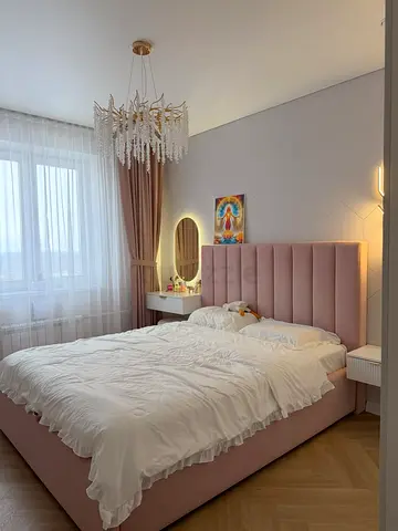 Pink upholstered double bed with headboard
