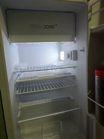 Clean single-door refrigerator in good condition - empty interior