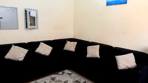 large black L-shaped sectional sofa in good condition. It is spacious and comfortable, perfect for a