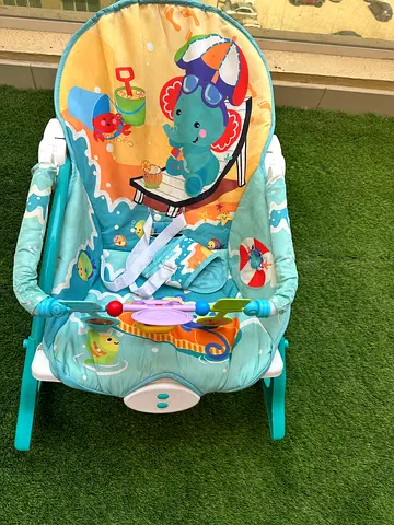 Baby rocker / bouncer seat with toy bar - light teal, used