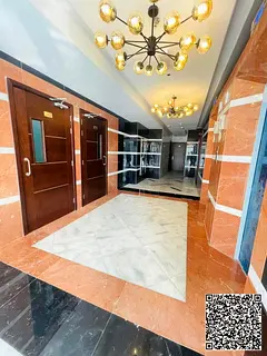 For rent in Ajman, Al Rawda area: a two-bedroom apartment with a living room, luxurious finishes, an