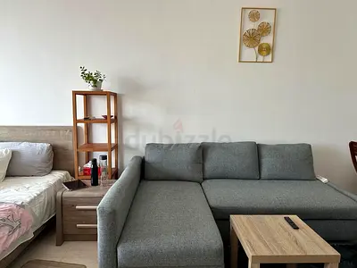 Grey L-shaped fabric sofa bed with chaise - good condition