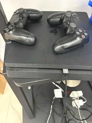 PlayStation 4 Slim with 2 Controllers - Good Working Condition
