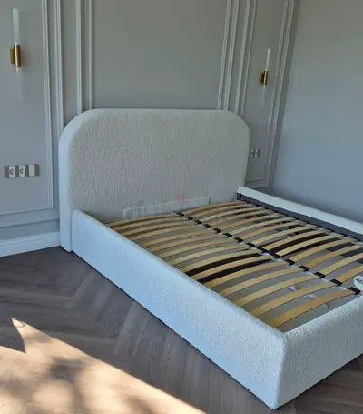 White upholstered double bed frame with slatted base