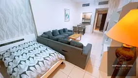 Furnished one-bedroom apartment with a living room at Ajman One Towers. Features include two bathroo