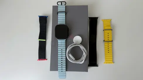 Apple Watch Ultra 2 with multiple interchangeable straps and charger