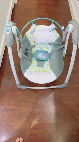 Baby swing rocker with soft seat and toys - good condition
