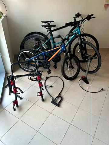 Two adult bikes and one kids bike with pump , car rack and lock in very good condition